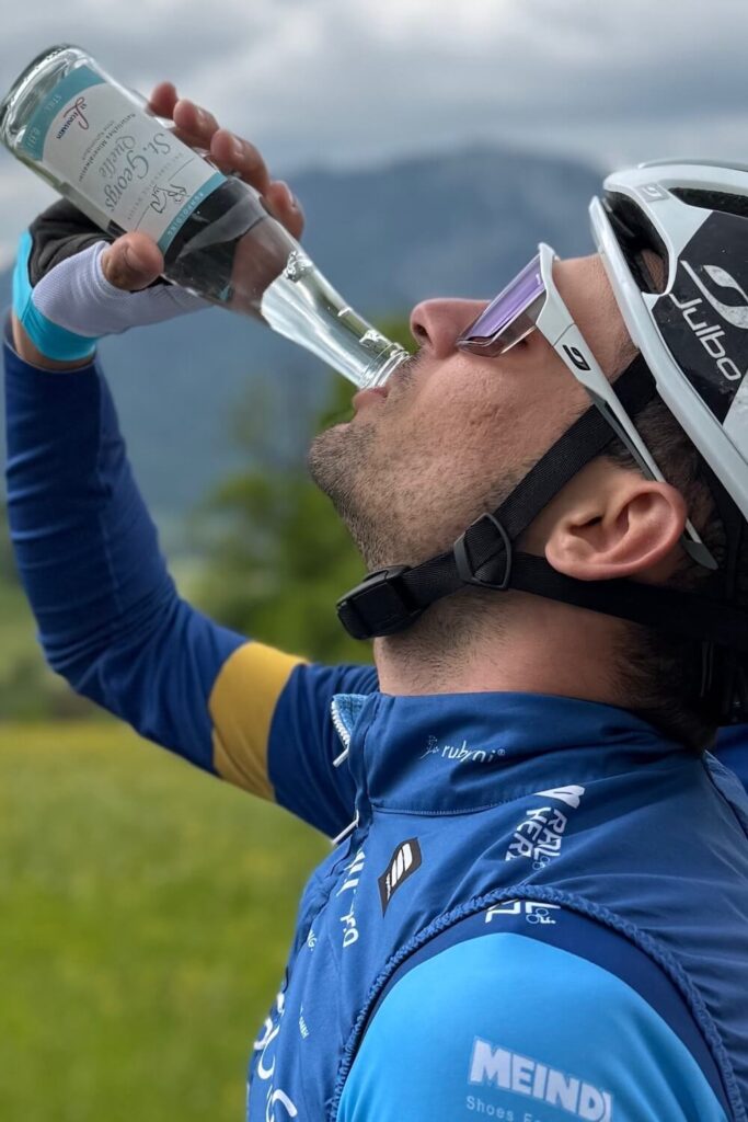 Professioneller Radfahrer trinkt aus 0,33-Liter-Flasche St. Georgsquelle